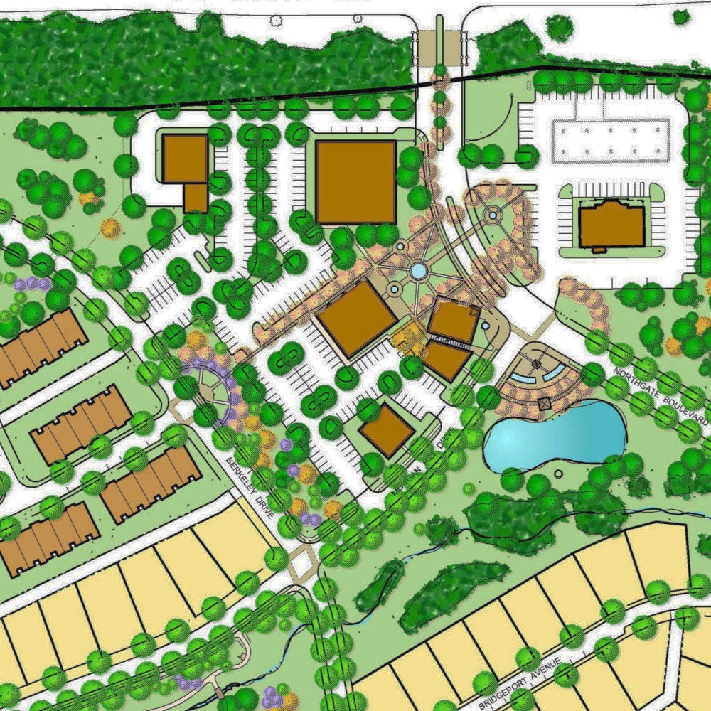 A detailed site plan showing a mixed-use development with parking areas, residential buildings, and green spaces, including a pond and walking paths.